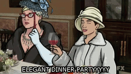 Two Women At Table One Holding Wine Glass Elegant Dinner Partyyyy GIF
