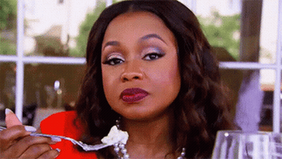 Two Women At Table One With Drink GIF