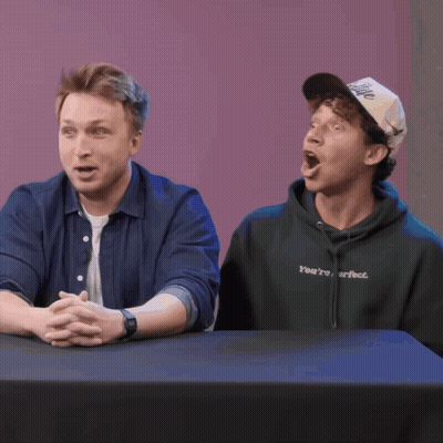 Two Women At Table With Coach Sweatshirt GIF