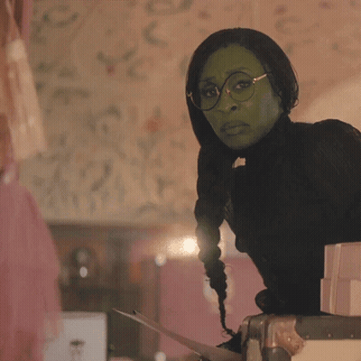Two Women Beside Each Other One In Green Mask GIF