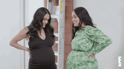 Two Women Bumps Their Pregnant Belly GIF