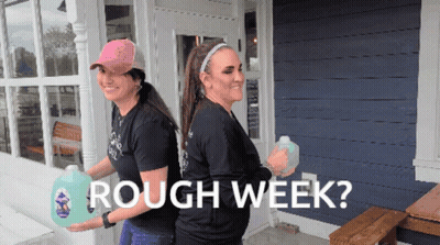 Two Women Carrying Gallons Of Rough Week GIF