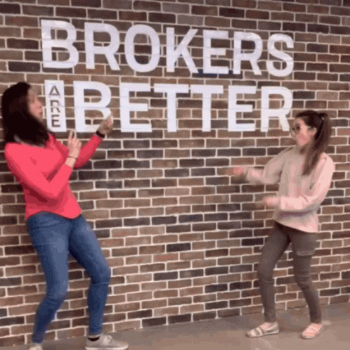 Two Women Dancing In Front Of Brick Wall Saying Brokers Are Better GIF