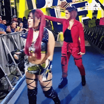 Two Women Dancing In Front Of Crowd With Girls Text GIF