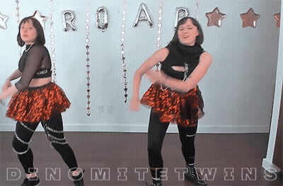 Two Women Dancing In Front Of Roar Balloons GIF