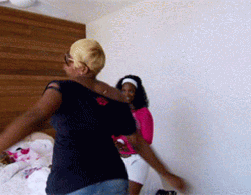 Two Women Dancing In Room With White Wall GIF