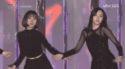 Two Women Dancing On Stage With UBC SBS GIF