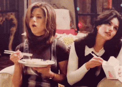 Two Women Eating Food With Chopsticks GIF