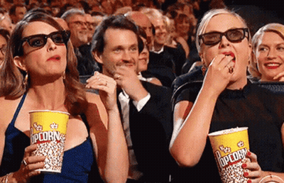 Two Women Eating Popcorn In 3D Glasses GIF
