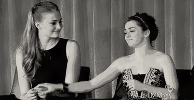 Two Women Facing Each Other One In White Tank Top GIF