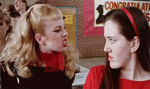 Two Women Fighting In Front Of Congratulations Sign GIF
