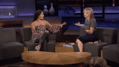 Two Women High Fiving In Resist Shirts GIF