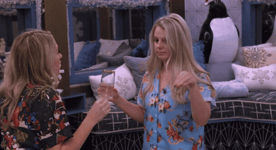 Two Women Holding Glasses GIF
