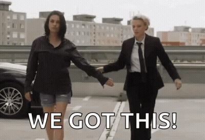 Two Women Holding Hands In A Parking Lot With The Words We Got This On The Bottom GIF