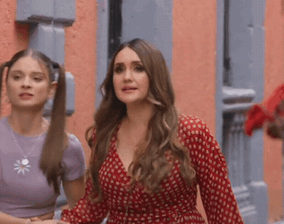 Two Women Holding Hands In Front Of Building GIF