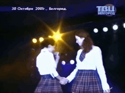 Two Women Holding Hands On Stage With TBU Logo GIF