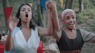 Two Women Holding Hands With Face Paint GIF