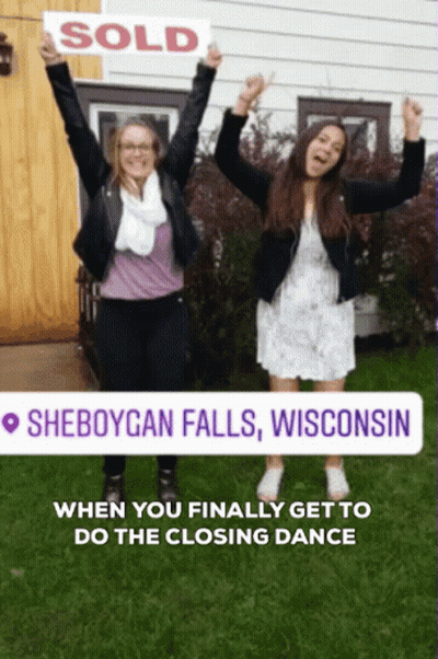 Two Women Holding Sold Sign In Front Of House In Sheboygan Falls Wisconsin GIF