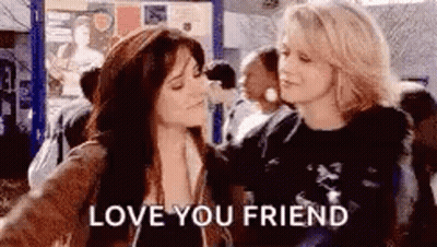 Two Women Hugging Crowded Area Love You Friend GIF