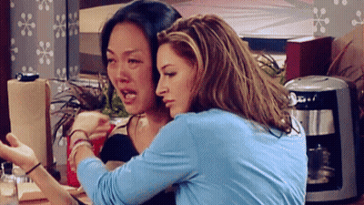 Two Women Hugging in Front of Keurig