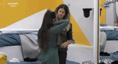 Two Women Hugging In Front Of Mirror GIF