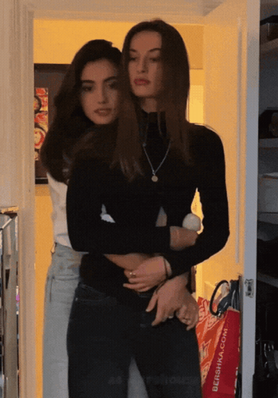 Two Women Hugging In Front Of Red Bershka Bag GIF