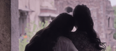 Two Women Hugging In Front Of Window GIF