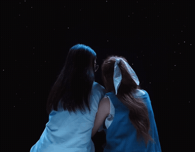 Two Women Hugging In Starry Night Sky GIF