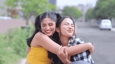 Two Women Hugging On Bench GIF