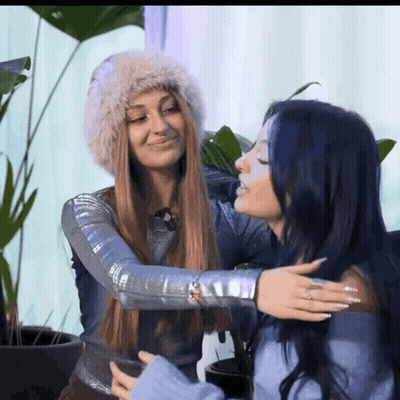 Two Women Hugging One With Blue Hair GIF