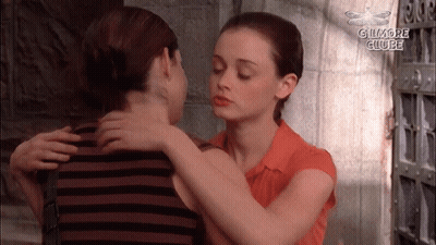 Two Women Hugging With The Words Gilmore Clube In The Corner GIF