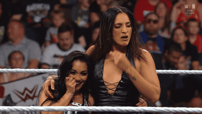 Two Women In A Wrestling Ring With The Word Win On The Bottom Right GIF
