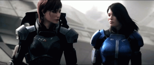 Two Women In Armor With N7 On Their Chests Stand Next To Each Other GIF