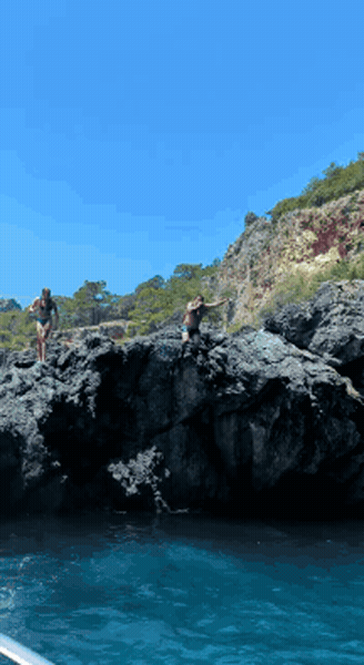 Two Women In Bikinis Jumping Into Water GIF