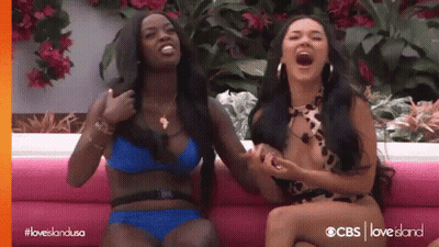 Two Women In Bikinis On Pink Couch GIF