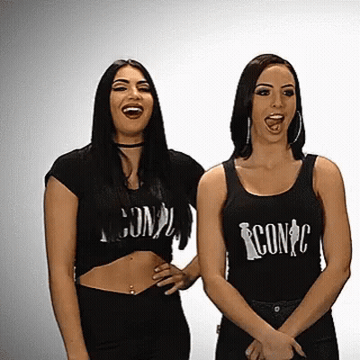 Two Women In Black Tank Tops With Iconc GIF