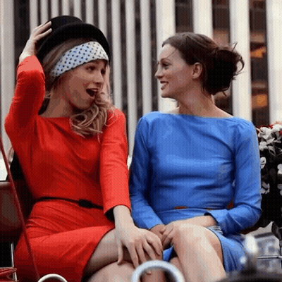 Two Women In Blue And Red Dresses Laughing GIF