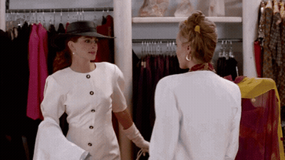 Dos mujeres en un armario mirando ropa GIF