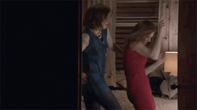 Two Women In Dresses Dancing On Bed GIF