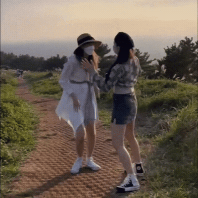 Two Women In Face Masks On Dirt Road GIF
