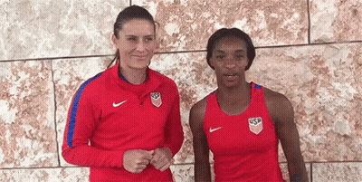Two Women In Front Of Brick Wall GIF