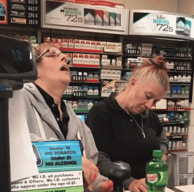 Two Women In Front Of Marlboro Display GIF