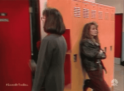 Two Women In Front Of Orange Lockers GIF