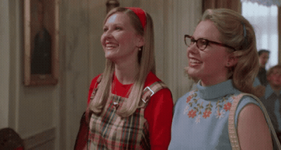 Two Women In Glasses And Plaid Dresses Smiling GIF