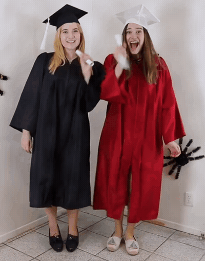 Two Women In Graduation Gowns With Diploma GIF