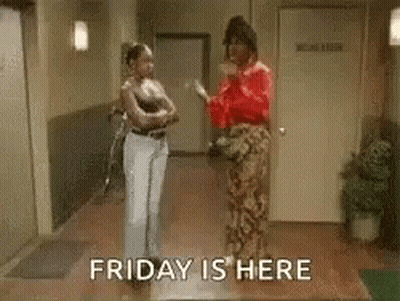 Two Women In Hallway Saying Friday Is Here GIF