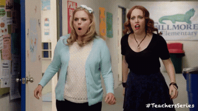 Two Women In Hallway With Fillmore Elementary Sign GIF