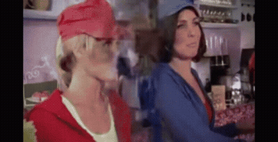Two Women In Hats In Kitchen GIF