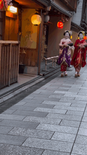 Two Women In Kimonos Walking Down Sidewalk GIF