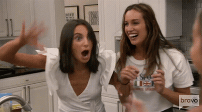 Two Women In Kitchen One Wearing Bravo Shirt GIF